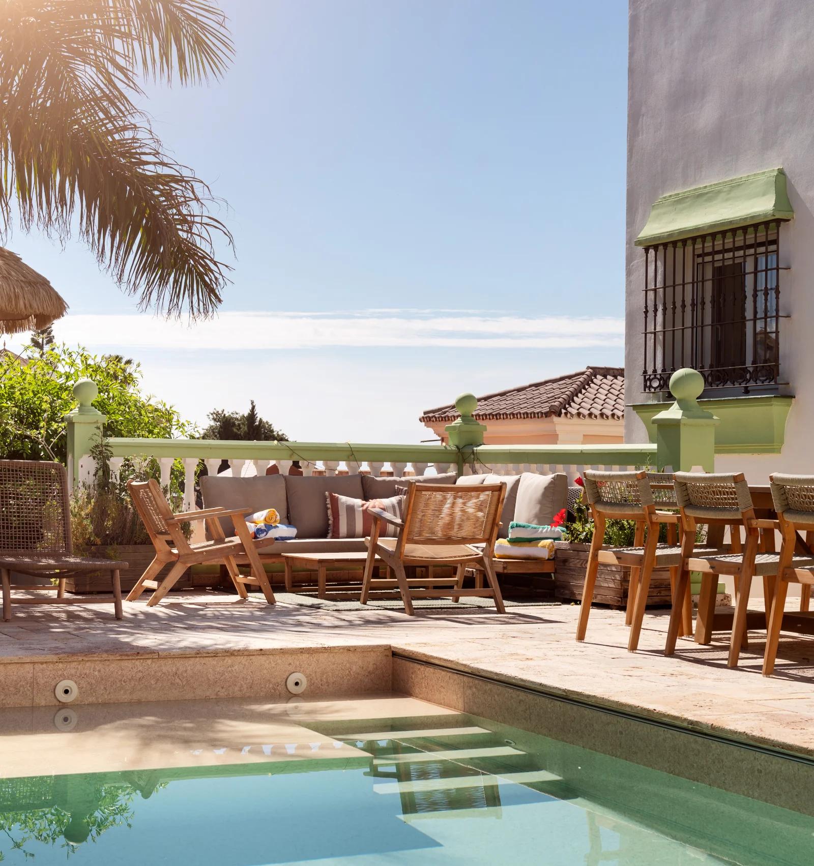 The terrace seating seen across the pool, with the shallow steps in the foreground