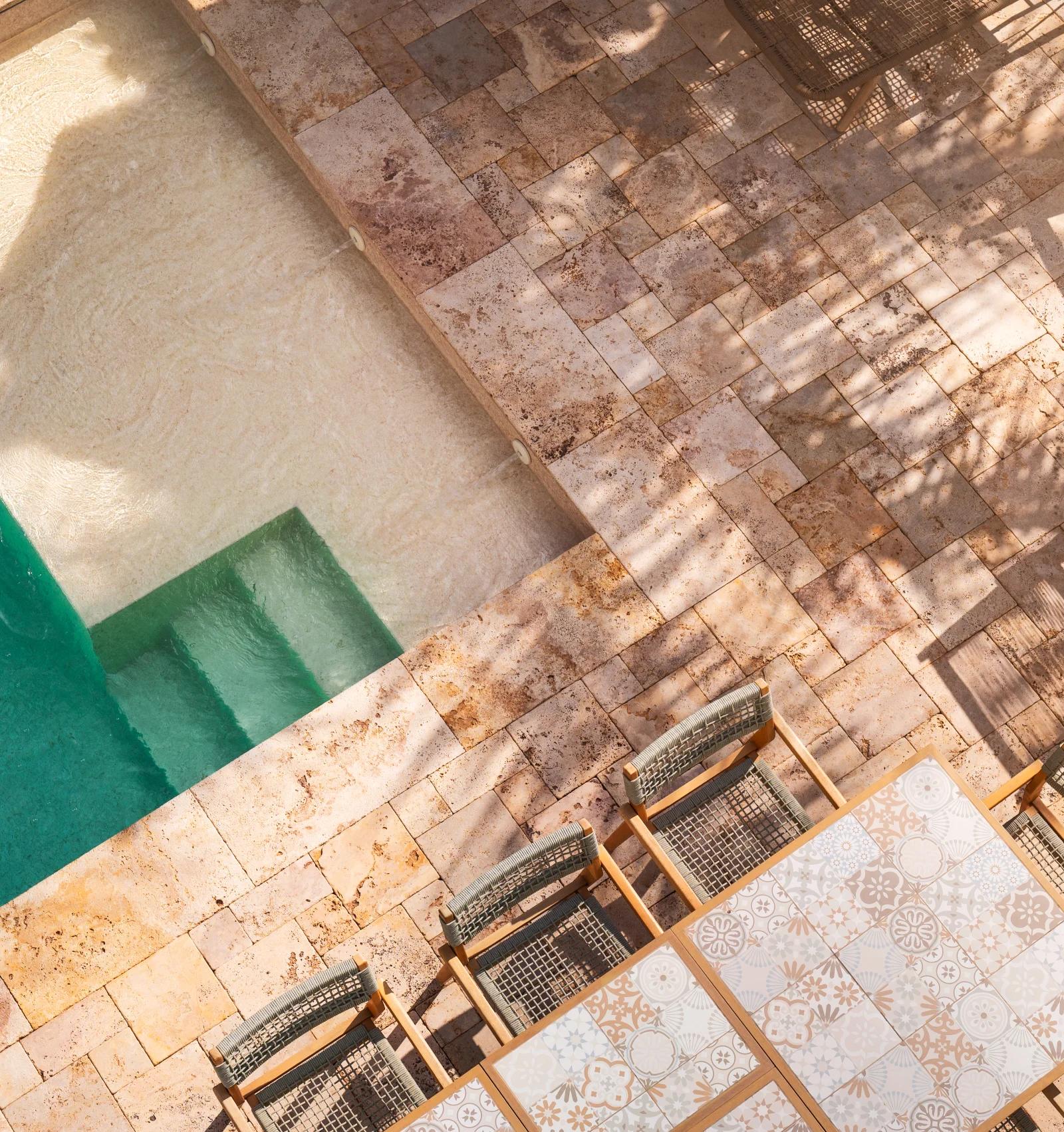 The pool from above, with the tiled outdoor table and chairs on the terrace alongside