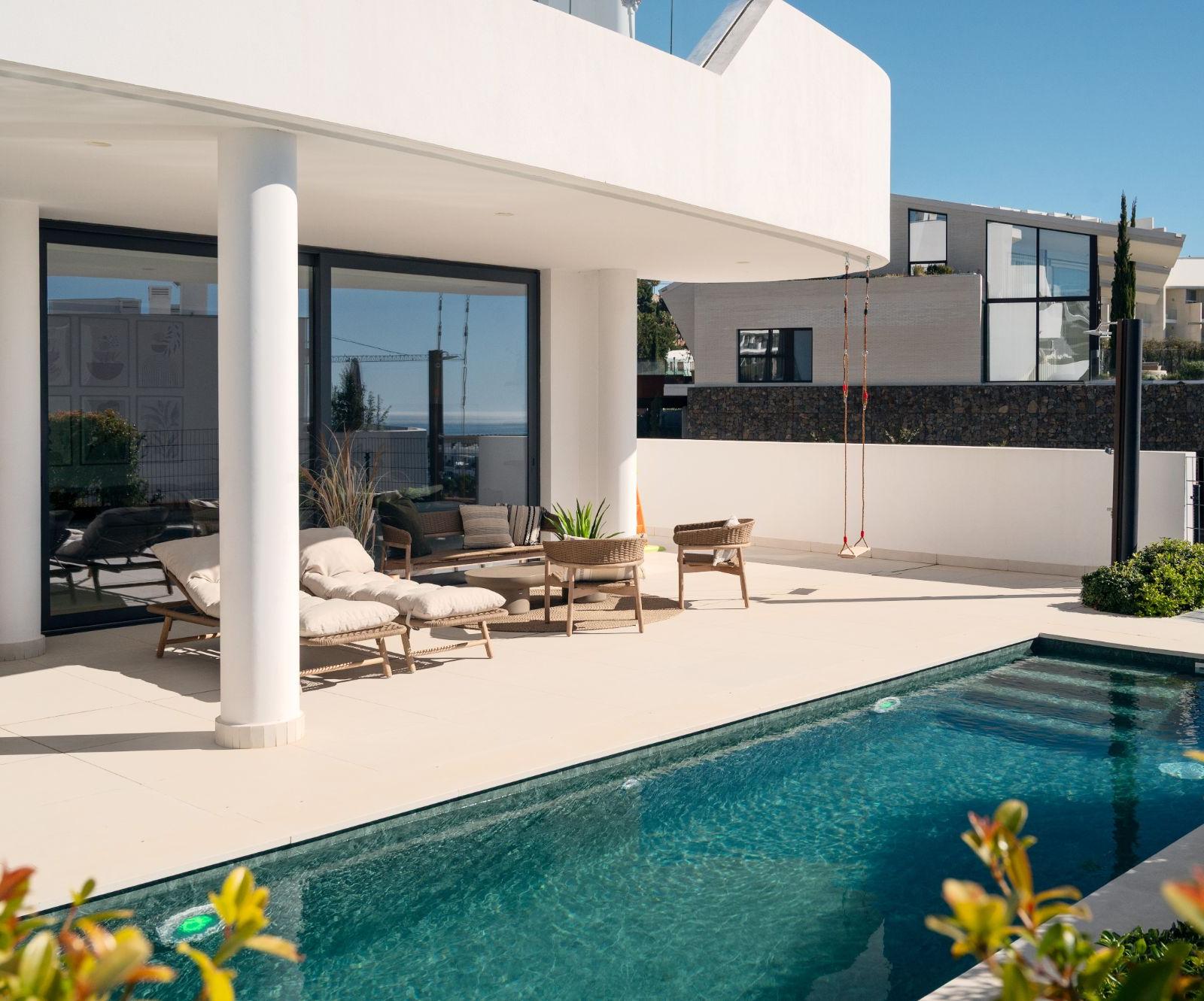 Private heated pool and sun terrace with loungers outside the apartment